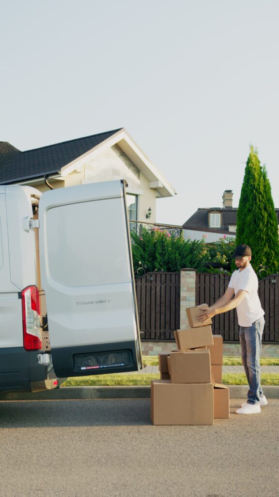 A man carrying boxes out of the truck