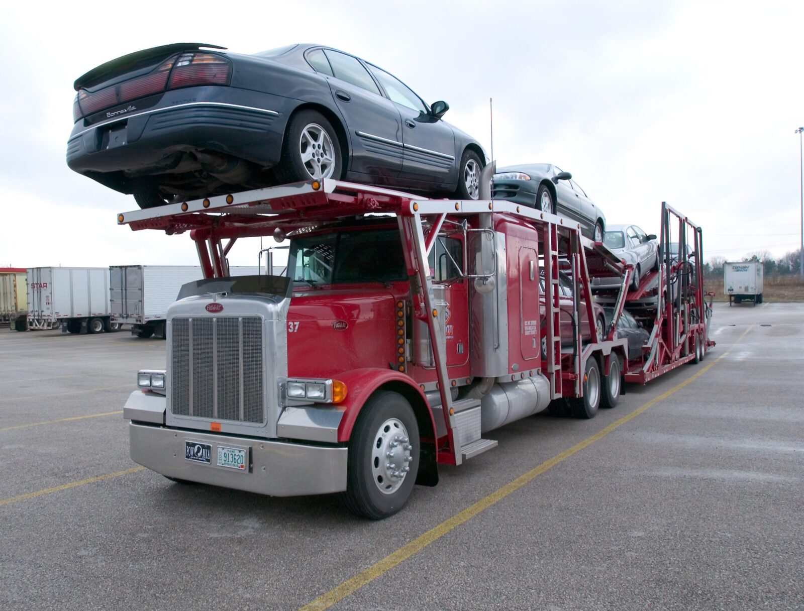 A red truck carrying a lot of cars  