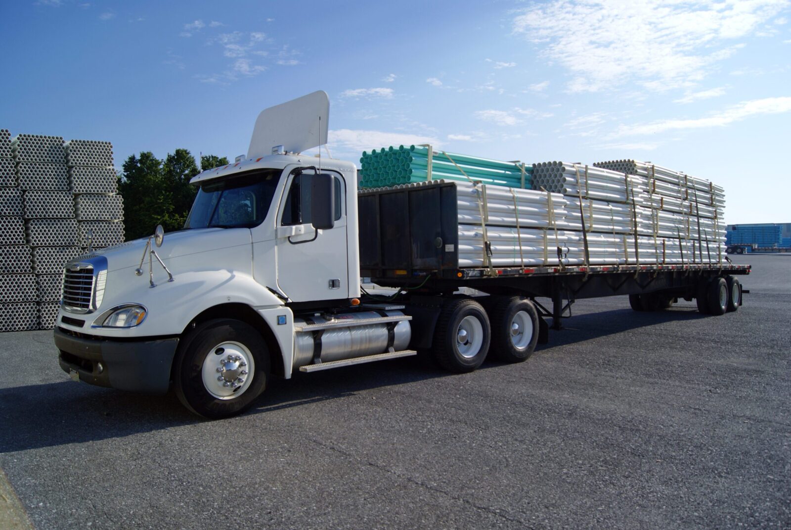 A truck carrying loads of tubes